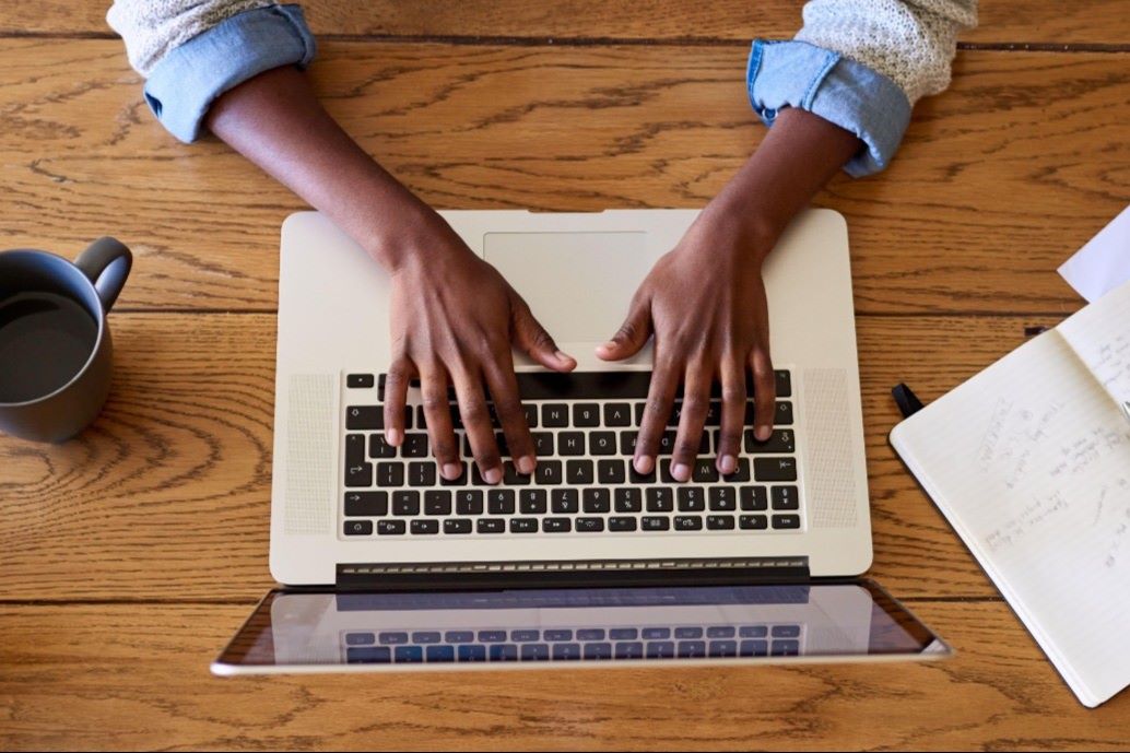 business student typing on computer