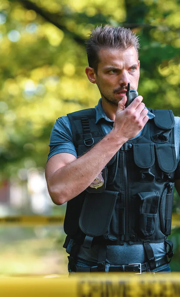 criminal justice professional speaking on walkie talkie