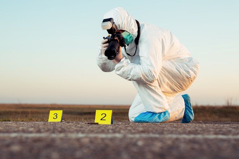 crime scene photographer with camera