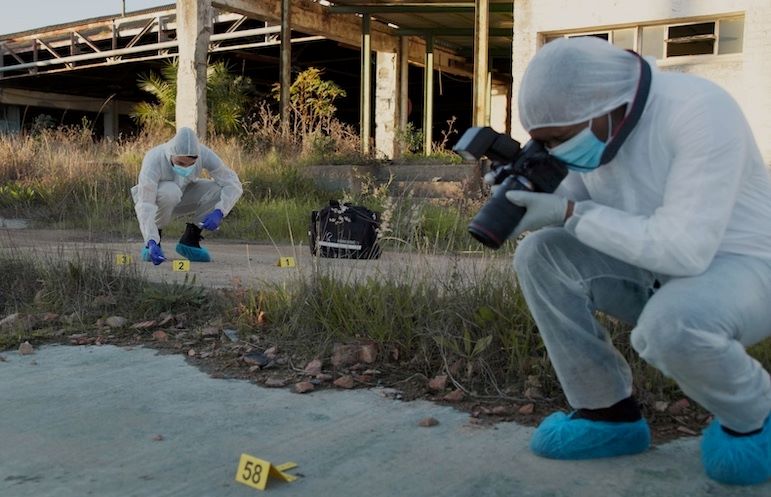 criminal investigators photographing evidence