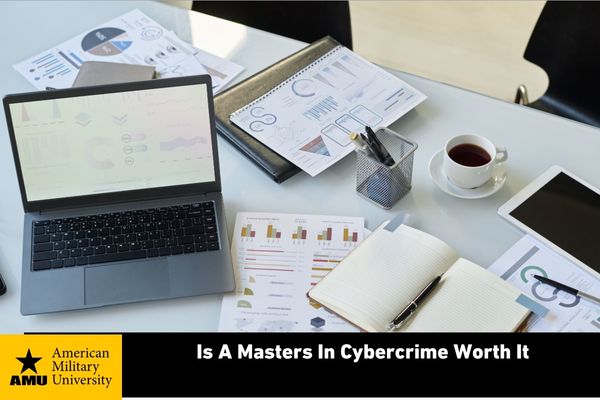 cybercrime master's student's desk containing paperwork and coffee