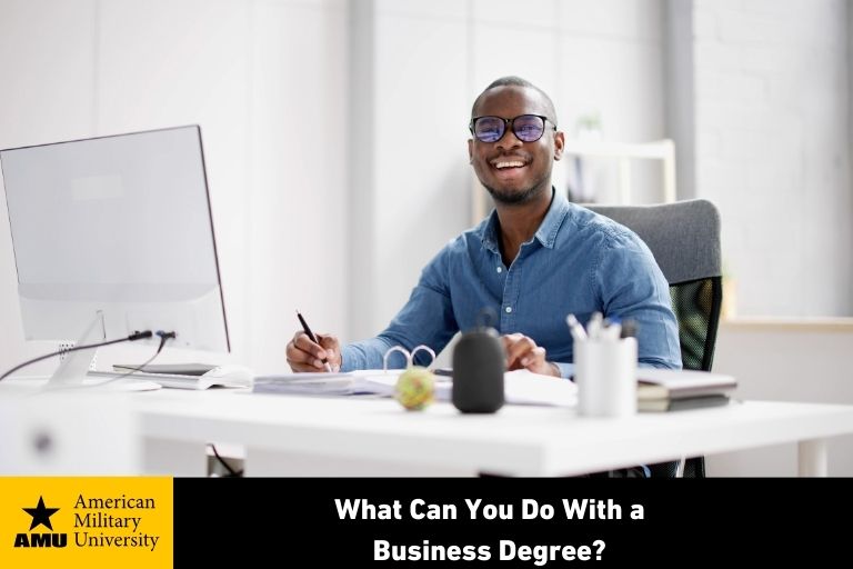 business degree student smiling at desk