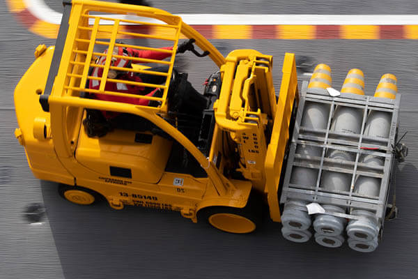 supply chain manager moving pallet with skid loader